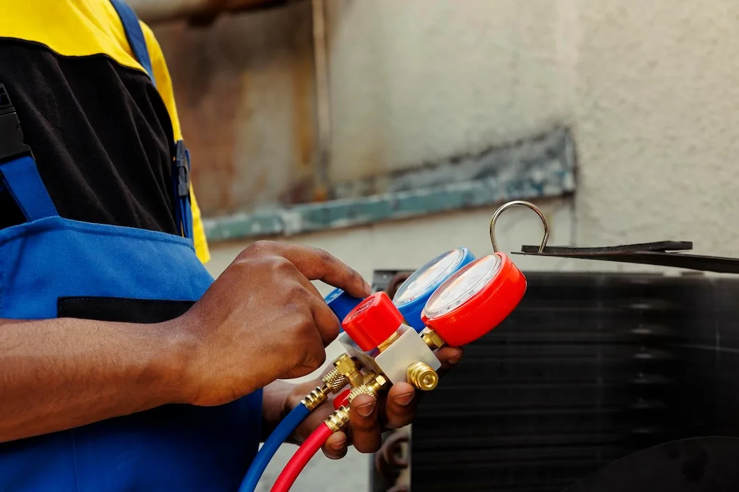 A professional HVAC technician monitoring some equipment