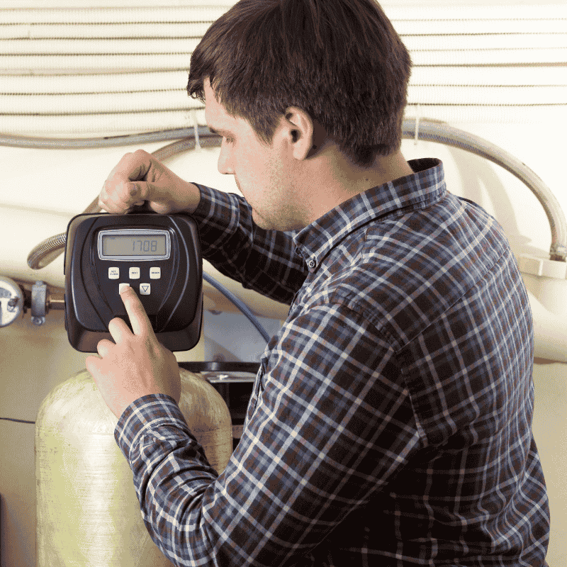Technician from LG Home Comfort installing a water purifier in Kitchener home