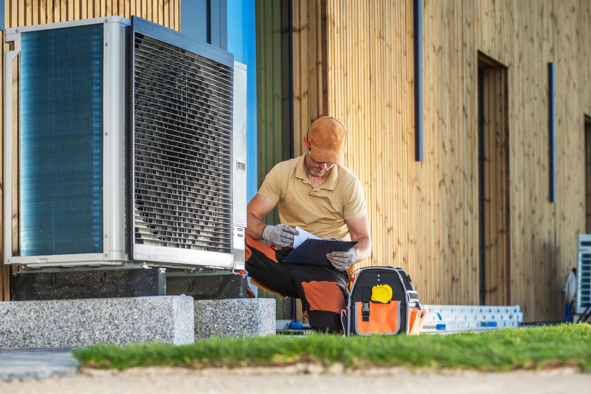 An HVAC technician inspecting a heat pump