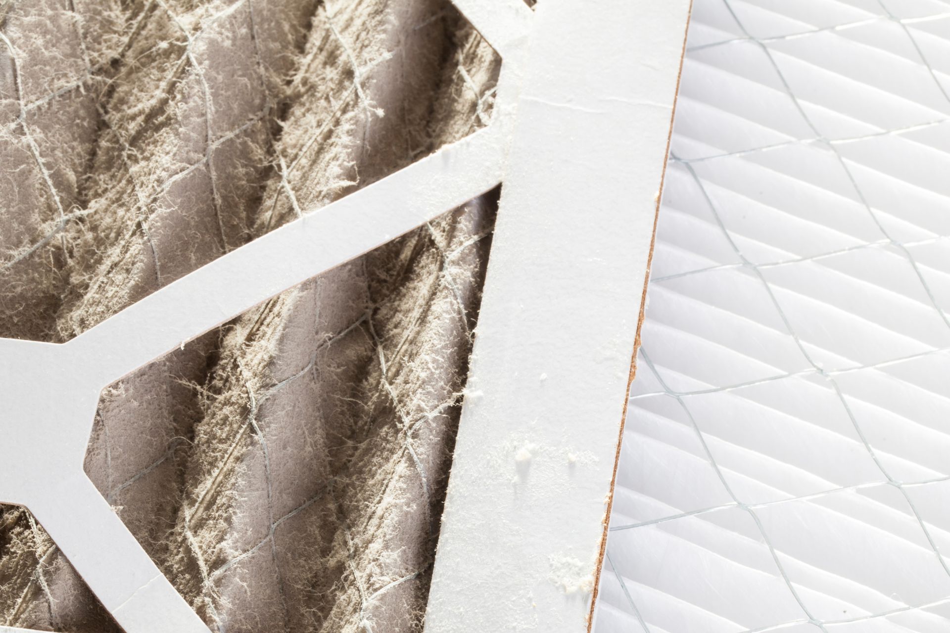 A dirty air filter, left, next to a clean air filter, right