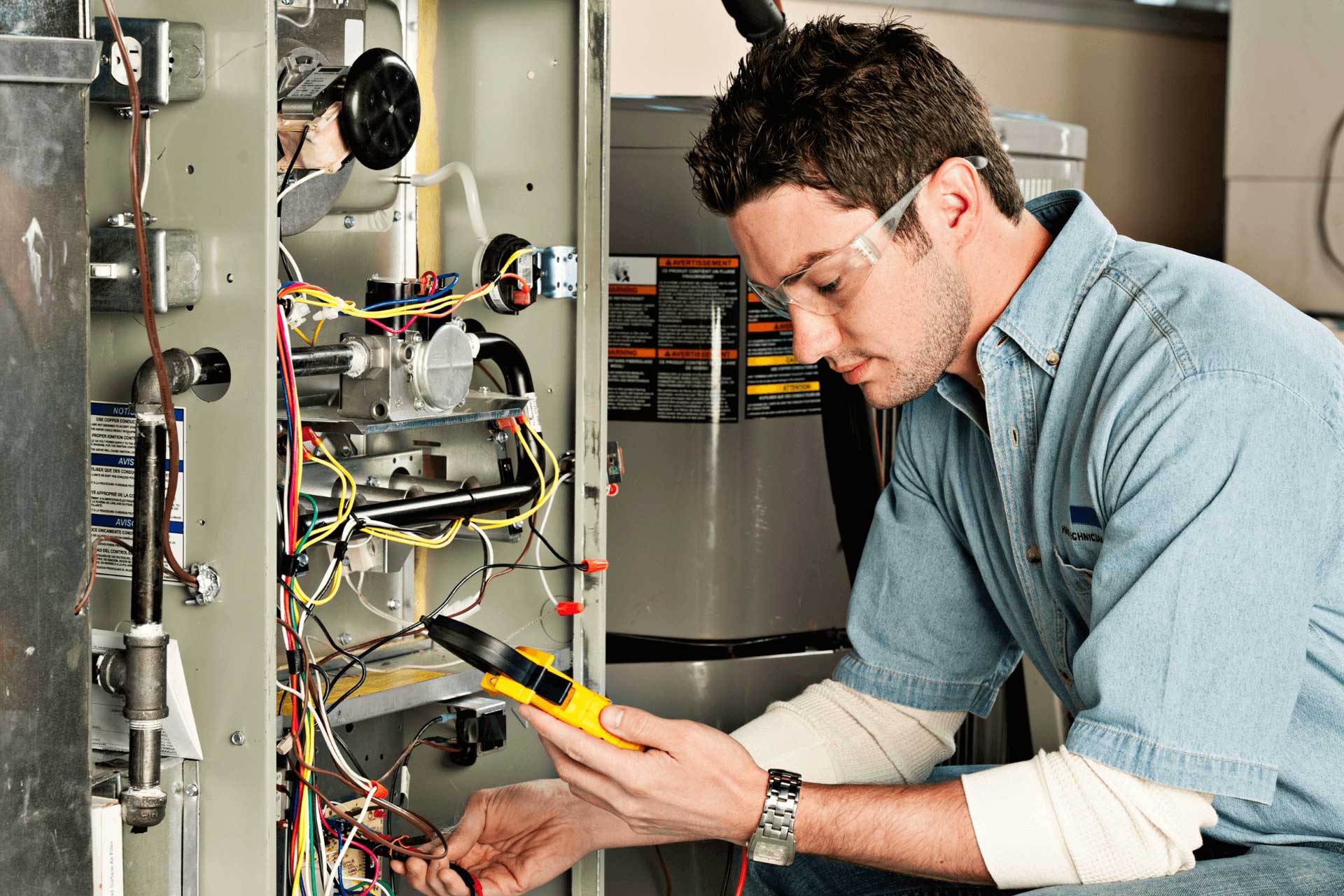 A technician testing a furnace system for a furnace burning smell