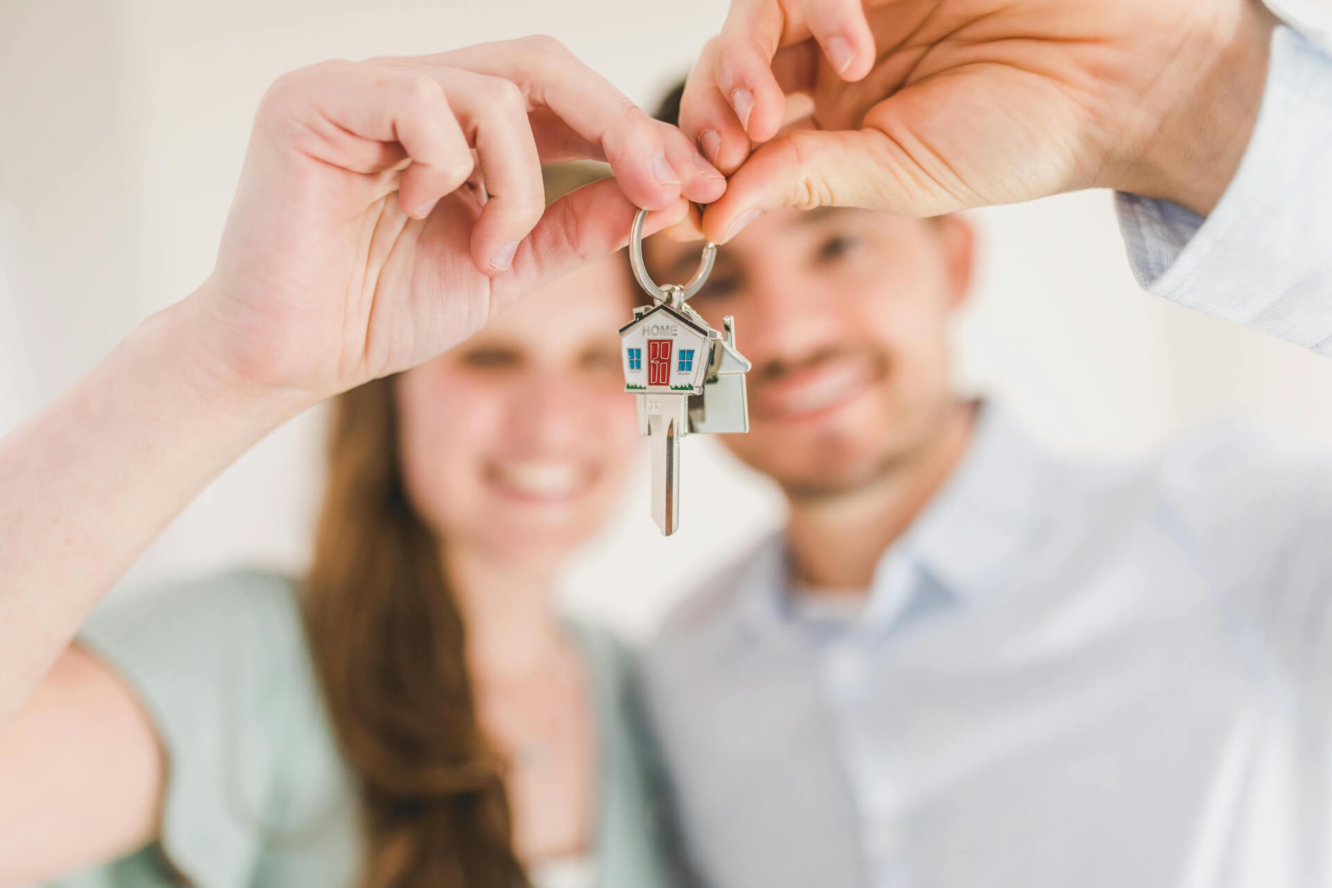 A happy couple holding the keys to their new house