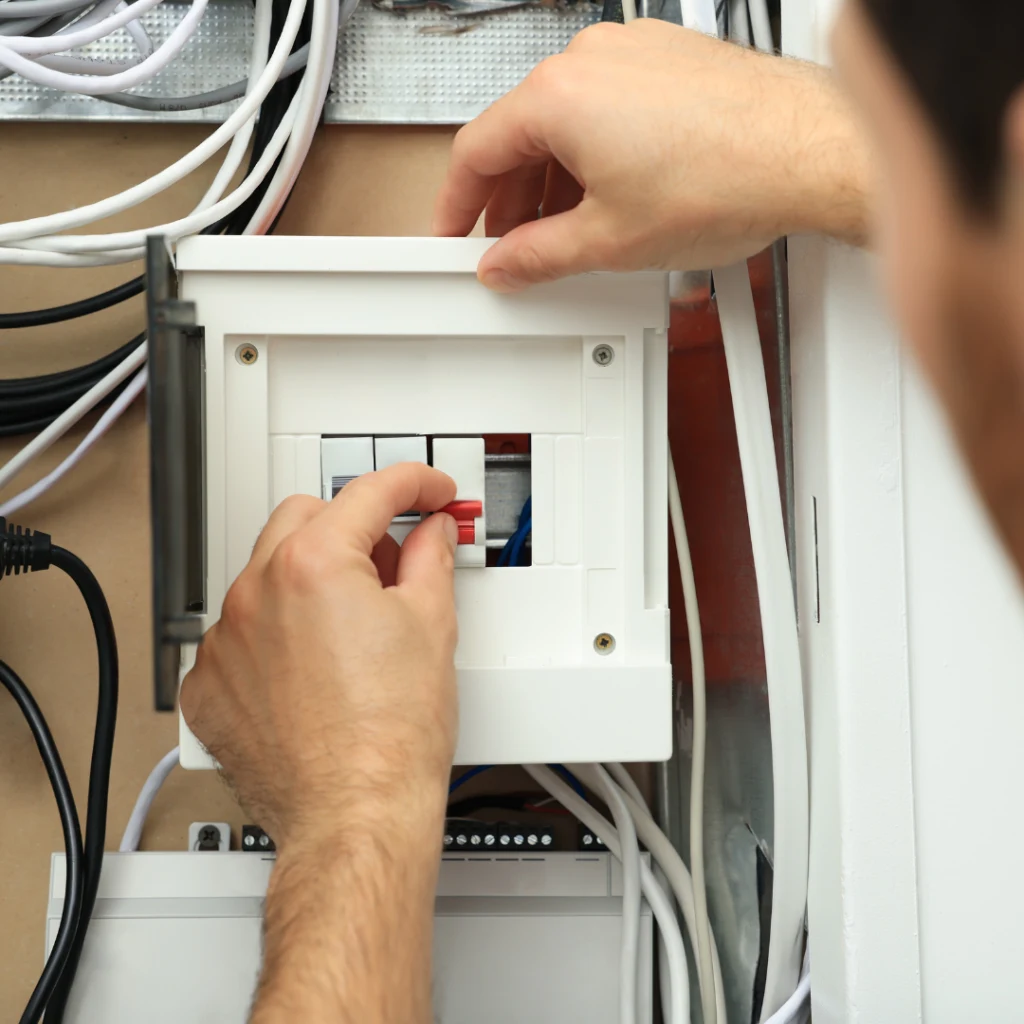 Electrician Changing fuse from a household fuse box