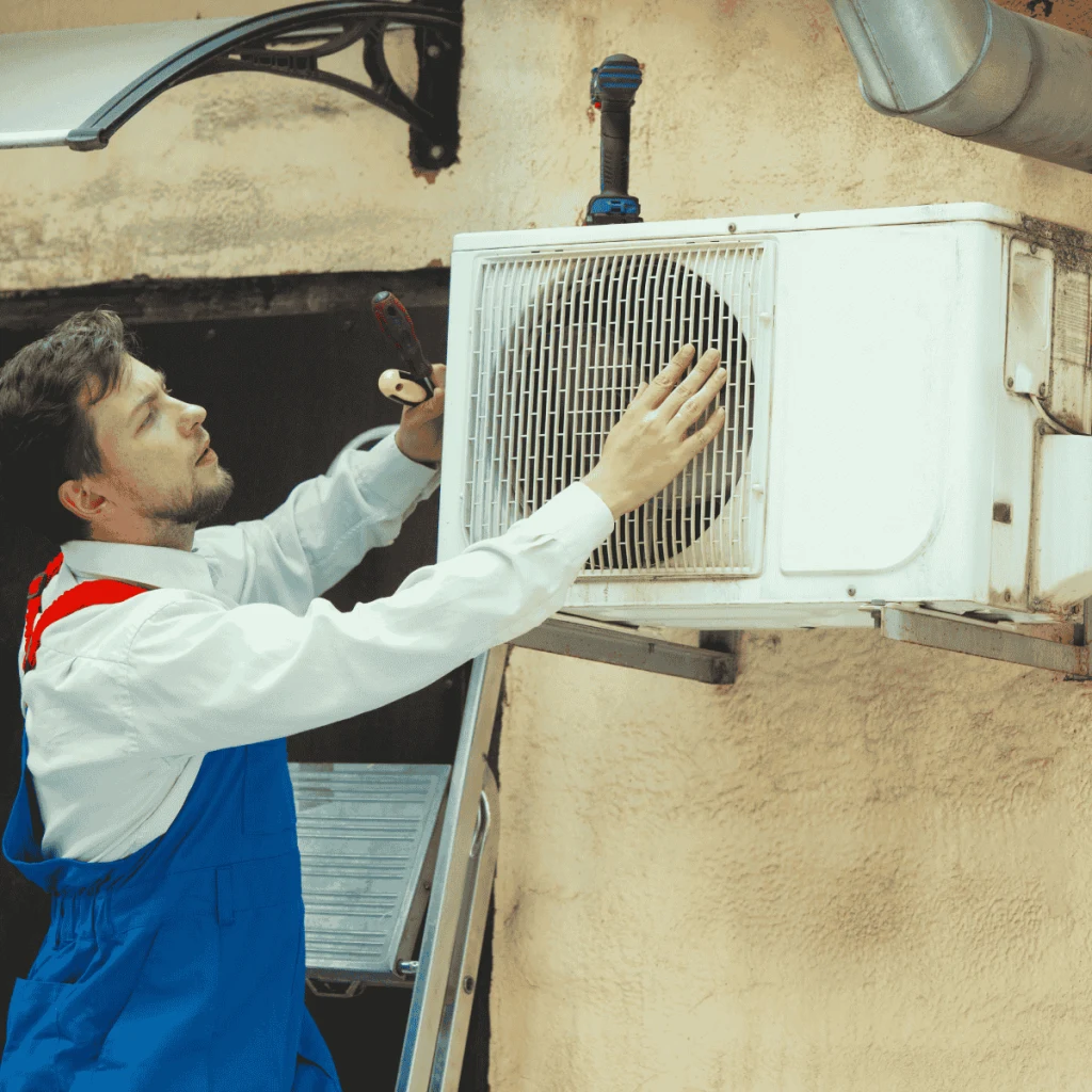 Man repairing AC Capacitor