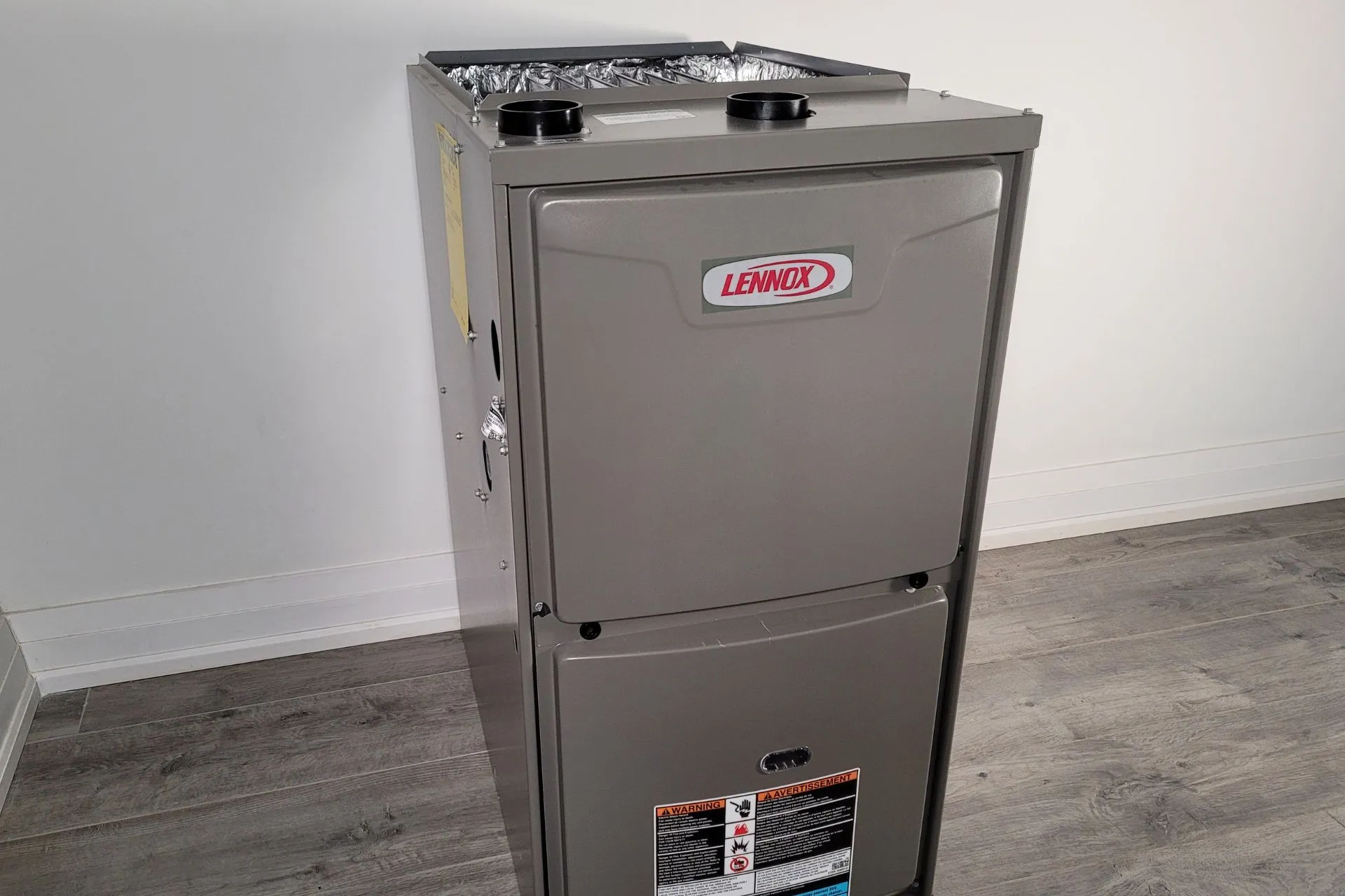 A gray furnace unit standing alone 